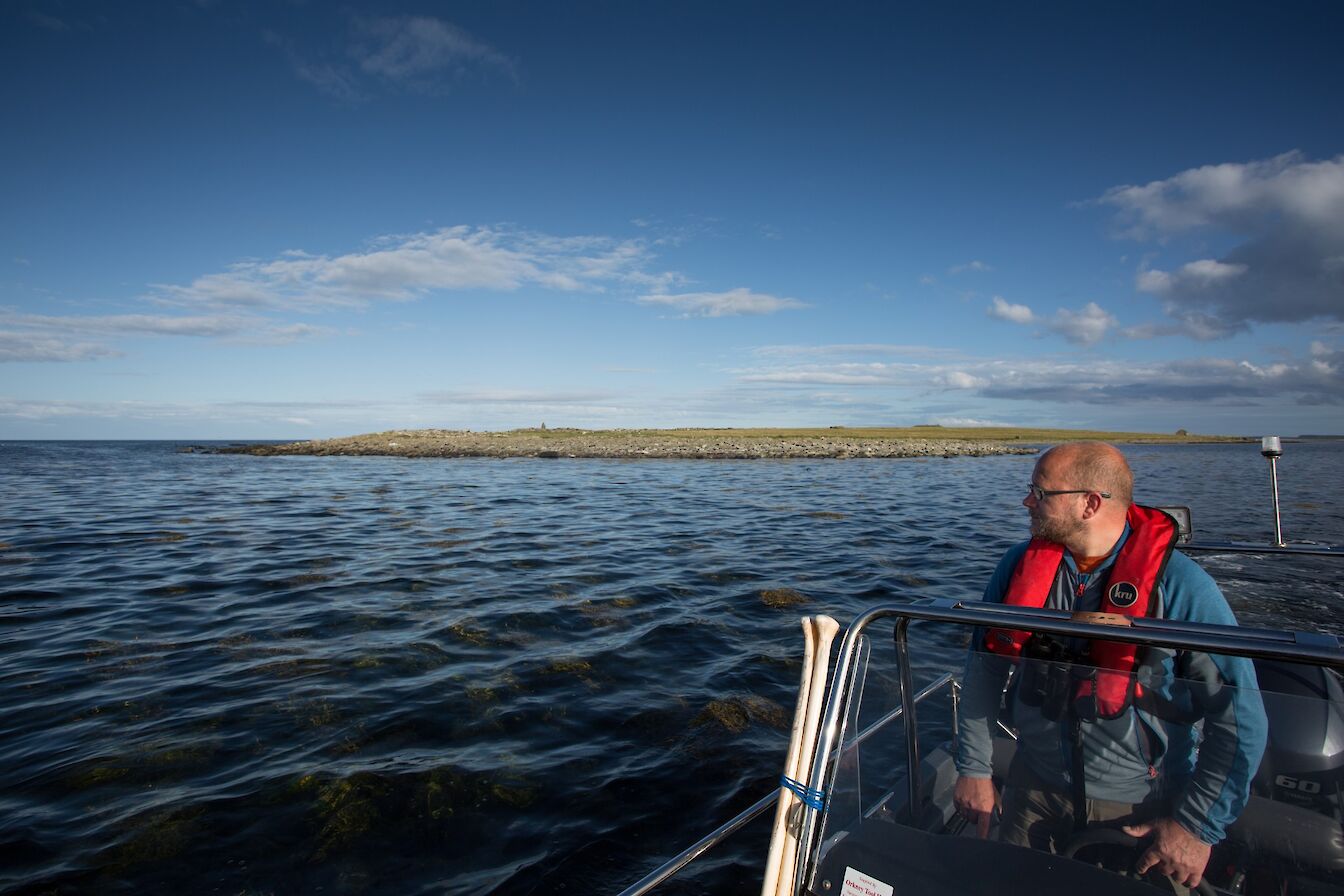 Island ranger Jonathan Ford with the Holm of Papay in the background