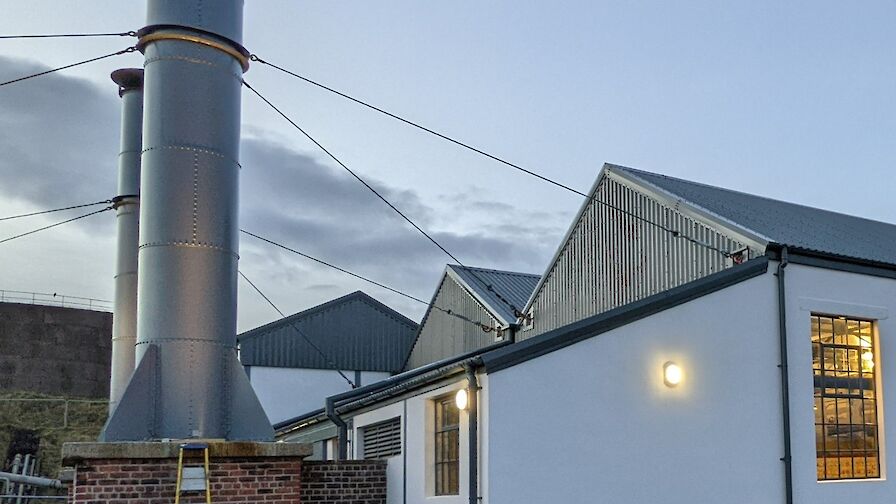 The chimneys in place on the gable of the refurbished museum
